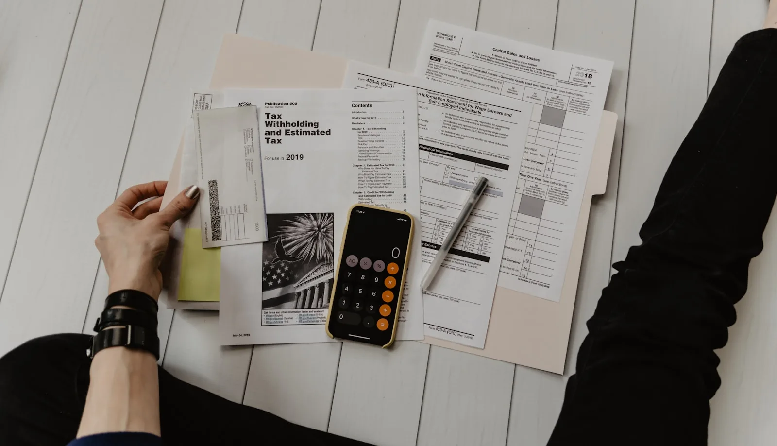 Accounts receivable ledgers and working capital balance statements being reviewed